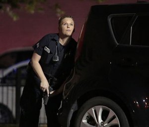 A police officer responding to shots being fired during a protest over recent fatal shootings by police in Louisiana and Minnesota. (Maria R. Olivas/The Dallas Morning News via AP)