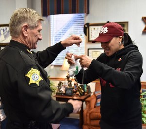 Coach Dawn Staley receives her Special Deputy badge from Sheriff Leon Lott in 2015.