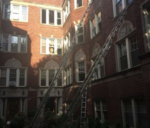 Two Chicago firefighters were taken to hospitals with minor injuries Wednesday after a staircase collapsed as they battled an extra-alarm fire. (Photo/CFD)