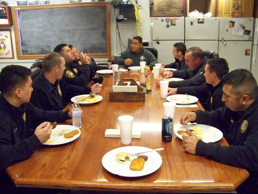 The crew relaxes with a meal together following a day of training and runs. 