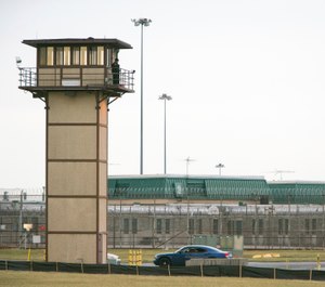 A prison guard stands on a tower during a hostage situation at James T. Vaughn Correctional Center in Smyrna, Del. (Suchat Pederson/The News Journal via AP, File)