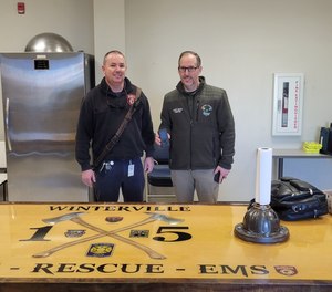Winterville Fire Chief David Moore (left) and Deputy EMS Chief Rick Britt (right) participate in a field test for the handheld HD digital broadcast paging receiver.