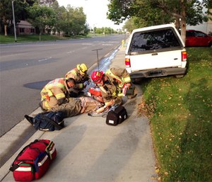 Paramedics attend a diabetic man who lost effective control of his vehicle due to hypoglycemia.