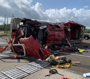 Two firefighters were rescued by civilians, but a third firefighter got his head and hand stuck under the truck. (Photo/Huntsville Fire Department)