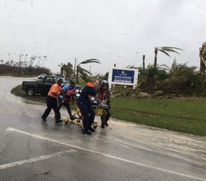 Coast Guard personnel help medevac a patient in the Bahamas during Hurricane Dorian.