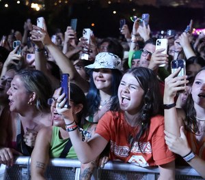Fans watch and sing along as Billie Eilish performs at Lollapalooza in Chicago's Grant Park on Aug. 3, 2023.
