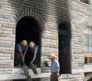 Firefighters work a one-alarm fire at 2424 Eager St. on July 7, 1992. Six of Tonya Lucas' seven children died and she was charged with setting the fire.