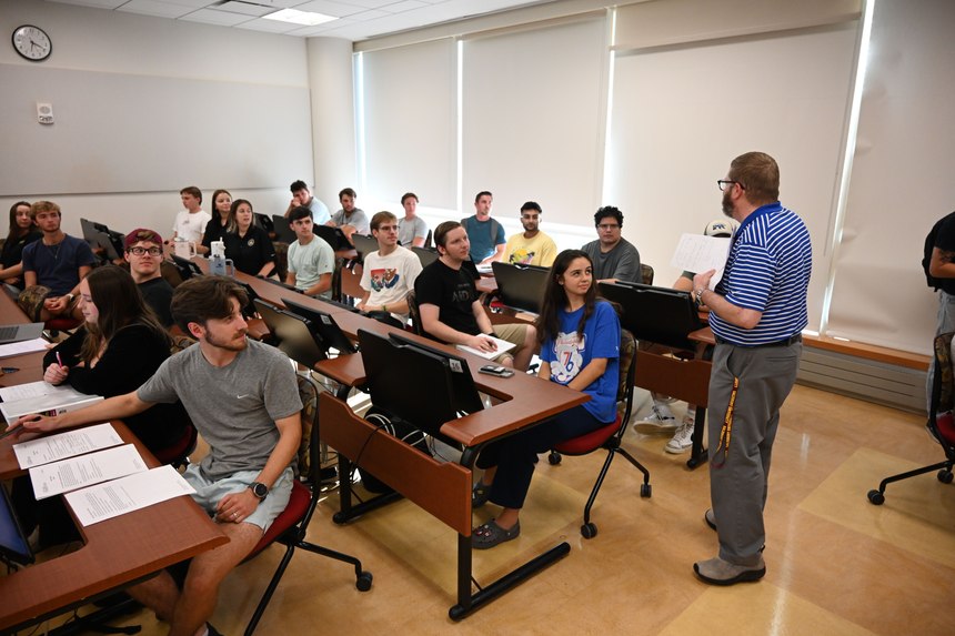 Dr. Weber and intern investigators work on a case study involving purchase card fraud.