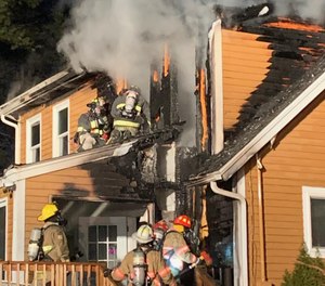 Firefighters from multiple departments battled a blaze at Kingston Fire Chief Graham Pellerin's home Sunday evening.