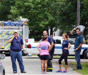 Emergency personnel from Berkeley County stand outside a campground surrounded by police tape near Moncks Corner, S.C., Tuesday, July 7, 2015, after an F-16 fighter jet smashed into a small plane over South Carolina. (Brad Nettles/The Post and Courier via AP)