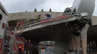 Watch: Okla. firefighters rescue driver, child as truck cab hangs from overpass