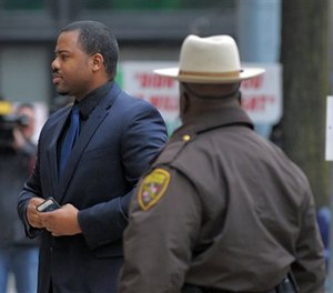 William Porter, left, one of six Baltimore city police officers charged in connection to the death of Freddie Gray, arrives at a courthouse as jury deliberations continue in his trial, Wednesday, Dec. 16, 2015. (AP Image)