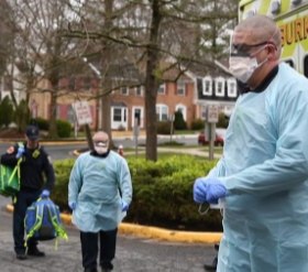 Fairfax County firefighters wearing proper PPE on a call.