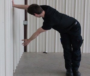 You can use any wall to perform this T-shaped rotational stretch. Work both sides.
