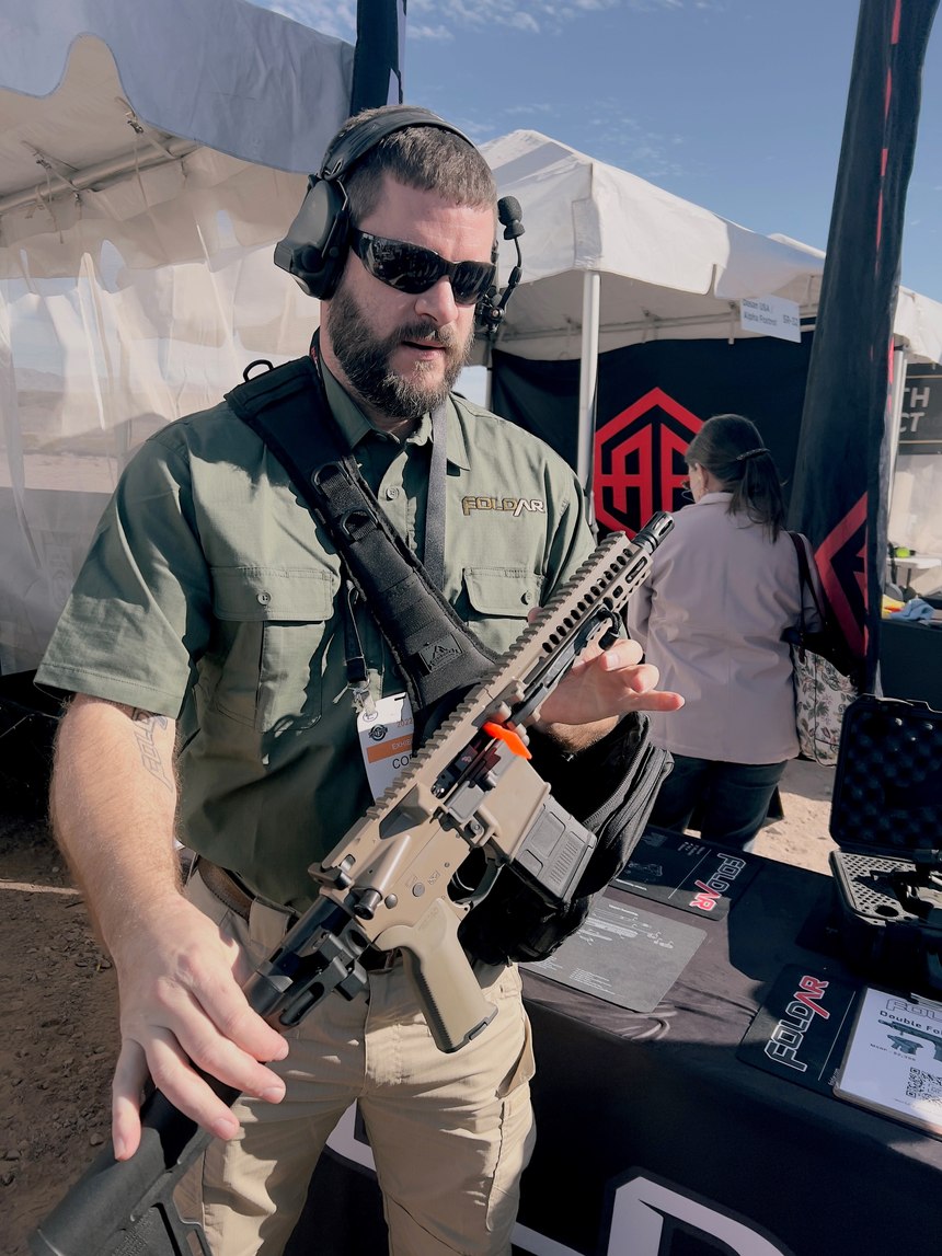 The FoldAR Double FoldAR is an AR-15 that has two hinged folds, coupled with positive locking devices, which allow the carbine to fit into a pouch. It is indistinguishable from a standard AR-15, once deployed. FoldAR’s Corby Hall showed us that it took only seconds to go from folded to “hot.”