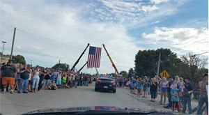 Officers in charge of traffic control didn’t need to do much. The mammoth crowds shut everything down lining the streets 10 to 20 people deep for miles. It was like a massive Fourth of July parade, but everyone was crying.