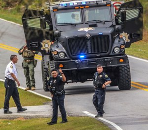 Clayton County police officers work a scene where a gunman reportedly shot a few Henry County police officers in Stockbridge, Ga., Thursday, April 4, 2019. (John Spink/Atlanta Journal-Constitution via AP)