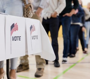 After a local man collapsed while in line to vote, an off-duty police officer and his nurse wife began CPR until the assistant principal arrived with a defibrillator and was able to help the man gain consciousness.