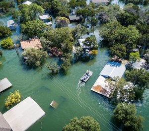Water rescue crew searches for survivors after flooding inundated an entire neighborhood.