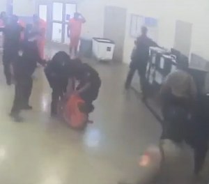 An inmate at the Guilford County Dentention Center in Greensboro, North Carolina, is restrained following an assault on a 72-year-old detention officer.