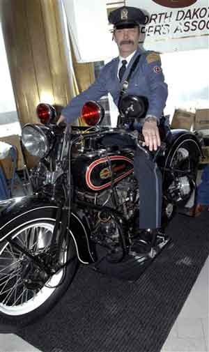 Retired North Dakota Highway Patrol Officer Jerry Seeklander sits on a restored 1936 Harley Davidson police motorcycle. Seeklander is also wearing a replica uniform from the same time period. The motorcycle is owned by the North Dakota Troopers Association, which was showing it off in Memorial Hall. Seeklander said the North Dakota Highway Patrol no longer uses motorcycles in its service.
