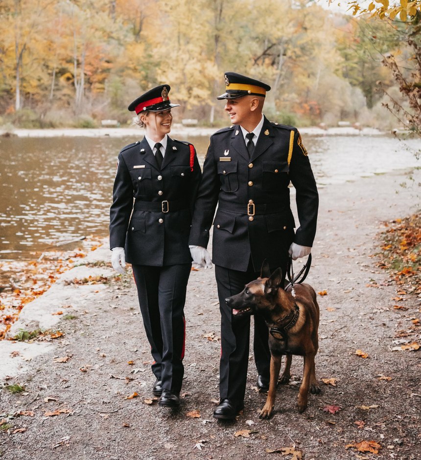 Constable Drew Harrison is pictured with his wife, Constable Kassandra Peekhaus, and his police K-9.