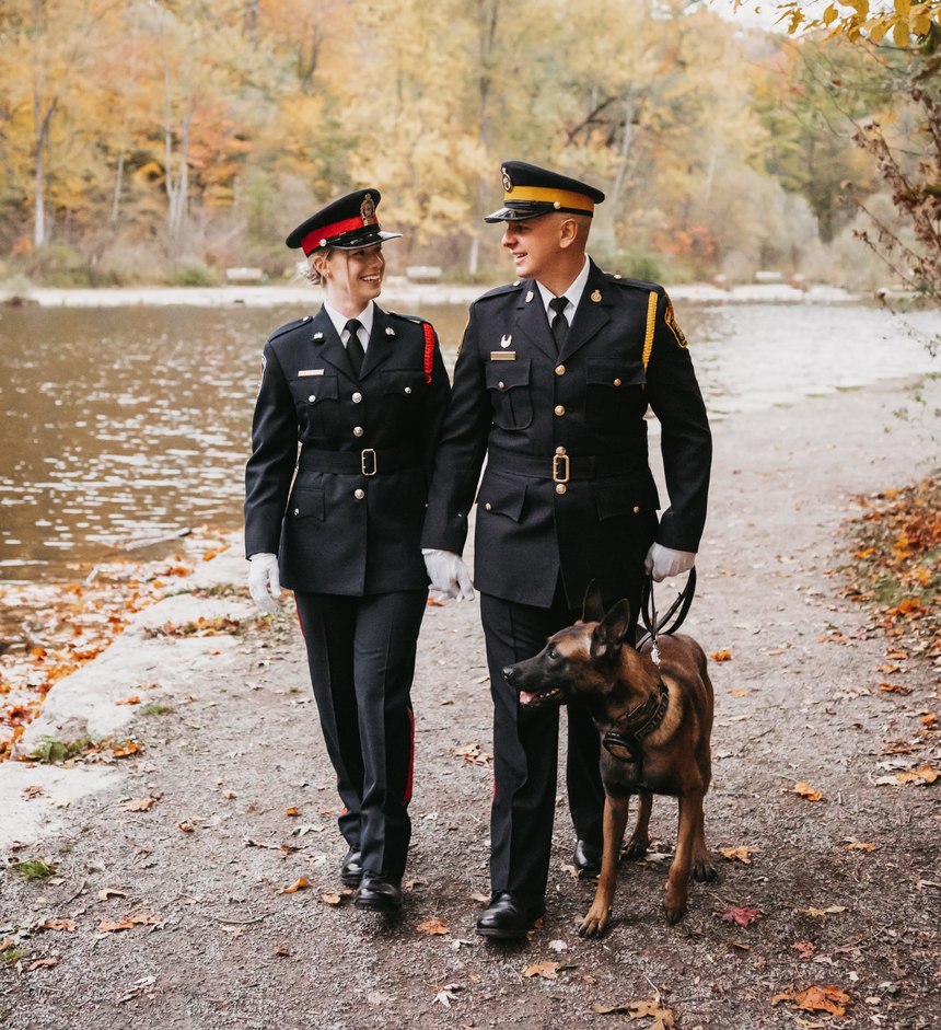 Constable Drew Harrison is pictured with his wife, Constable Kassandra Peekhaus, and his police K-9.