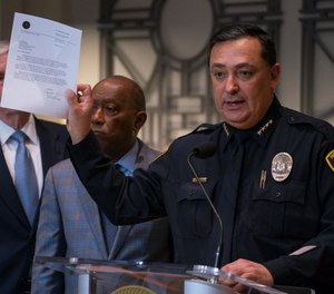 Houston Police Department Chief Art Acevedo holds up a letter from the FBI announcing the bureau's civil rights investigation related to the deaths of two people during the no-knock raid by narcotics officers that killed two people and injured five police officers last month, during a press conference from Houston City Hall, Wednesday, Feb. 20, 2019.