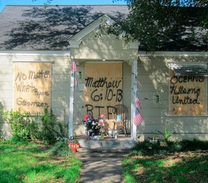 A makeshift memorial with flowers and candles that has been set up at the front door of a home in Houston where a couple who lived inside were killed during a Jan. 28 drug raid by Houston police.