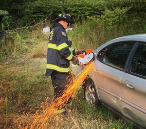 A Hubbardston (Mass.) firefighter uses the department's rotary saw at an extrication scene.
