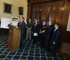 New Hampshire Gov. Chris Sununu and others hold a presentation to launch a statewide push for the SAFE app. (Photo/NHPR.org)