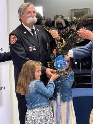 With two granddaughters at his side, Chief Goldfeder accepted the award, which recognizes leaders with exemplary impact on the national level in firefighter advocacy and fire prevention, mitigation and response.