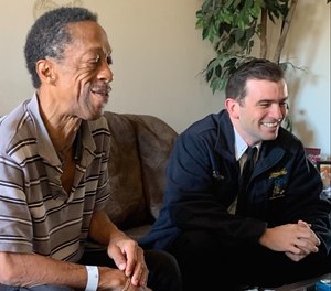 Lt. Ben Thompson (right) sits with a former C.A.R.E.S. patient and current friend of the program, Curtis Falconer.