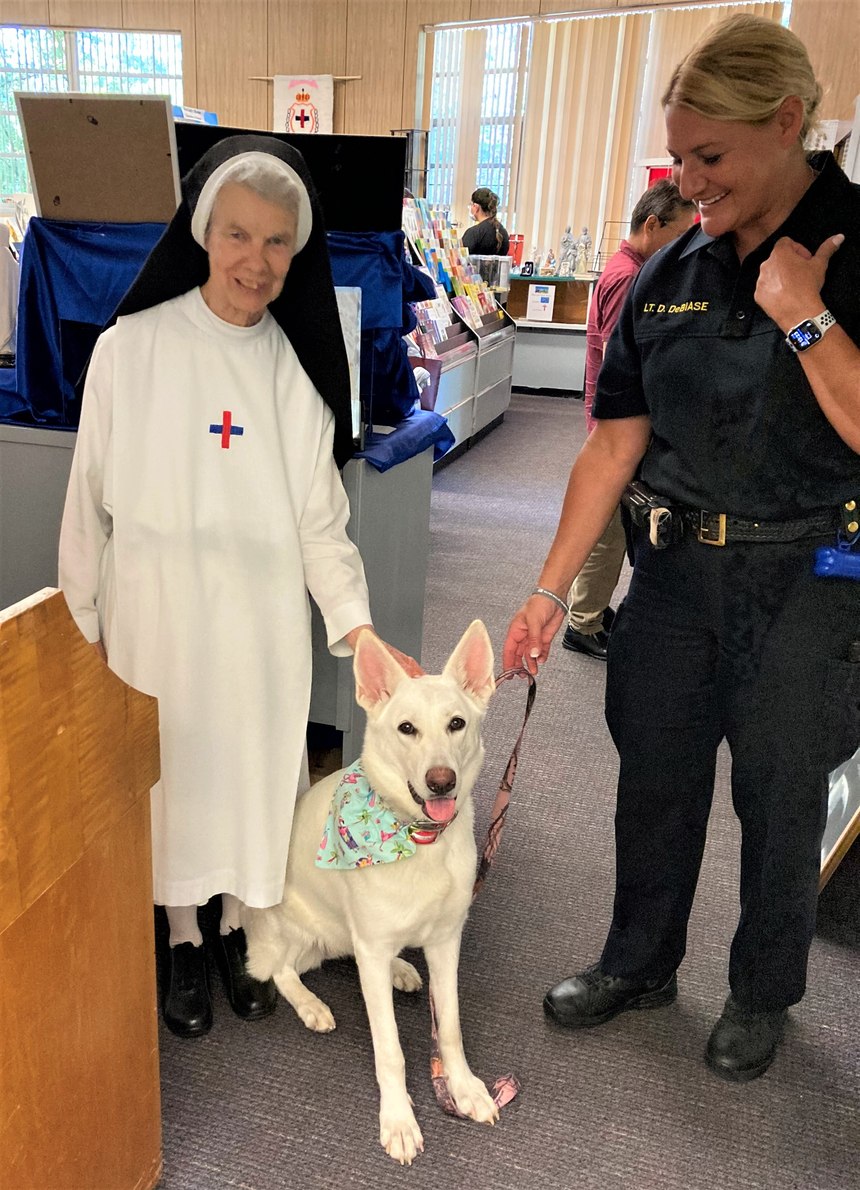 Lt. Denise DeBiase (at right) with her trained support K-9 Angel.