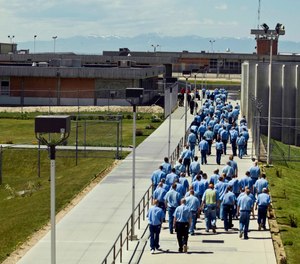 In this June 15, 2010 file photo, inmates walk to the dinning hall from their cell block at the Idaho State Correctional Institution outside Boise, Idaho.