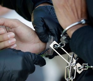 An immigrant who entered the United States illegally is checked before boarding a deportation flight to El Salvador by U.S. Immigration and Customs Enforcement.