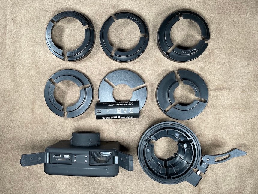 The box includes the device, battery, seven scope adaptors, a metal locking collar USB-3 to USB-C cable and a manual.