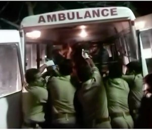 Officials put an injured person into an ambulance following a fire at a temple in Kollam, in the southern Indian state of Kerala, early Sunday. (Asianet News via AP Video)