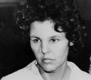 In this Oct. 21, 1981 file photo, Judith Clark is taken into police custody in Nanuet, N.Y. (AP Photo/David Handschuh, File)