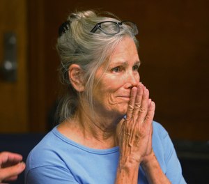 Leslie Van Houten reacts after hearing she is eligible for parole during a hearing at the California Institution for Women in Corona, Calif. (Stan Lim/Los Angeles Daily News via AP, Pool, File)
