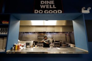 Chef Samara Henderson checks a lunch order paper at Inspiration Kitchens in Chicago. Image: AP Photo/Nam Y. Huh
