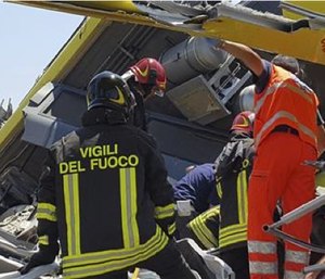 Italian firefighters Vigili del Fuoco inspect the wreckage of two commuter trains after their head-on collision. (Italian Firefighter Press Office via AP)
