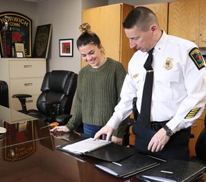 A recent Mitchell College graduate participates in an internship with a local police department.