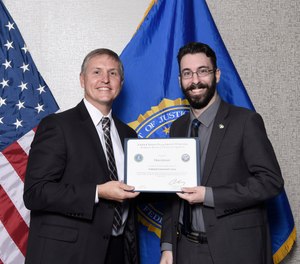 The author (right) is pictured on graduation day with FBI Assistant Director Tim Dunham.