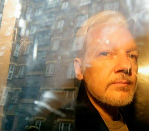 WikiLeaks founder Julian Assange is taken from court, where he appeared on charges of jumping British bail seven years ago, in London. (AP Photo/Matt Dunham, File)