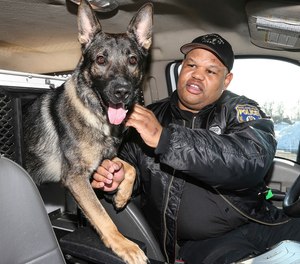Police Officer Alvin Outlaw and his K-9 partner, Thor, Outlaw and Thor have gained notoriety with Thor's beloved Twitter persona and their good deeds in the community Friday, February 14, 2014. (Steven M. Falk/Philadelphia Daily News/TNS)