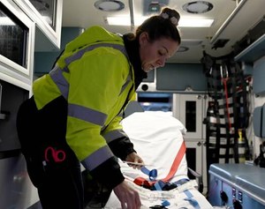 Kat Benoit preps the ambulance she will ride in ahead of starting a 24-hour shift in Somerville, Mass., on Nov. 16, 2021.