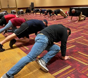 Kerrigan and Moss lead FDIC attendees in stretches and exercises.