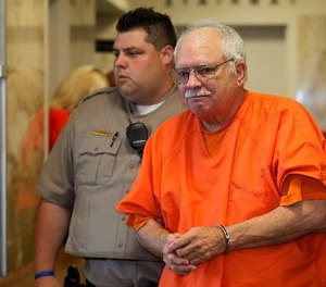 In this May 31, 2016 file photo, Robert Bates, a former Oklahoma volunteer sheriff's deputy who said he mistook his handgun for his stun gun when he fatally shot an unarmed suspect in 2015, is escorted from the courtroom following his sentencing at the courthouse in Tulsa, Okla.