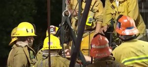 A firefighter fell and suffered a moderate injury, requiring crews to hoist the firefighter from a lower level.